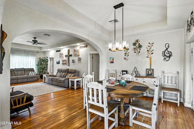 1624 Vinton Rd, Anthony, NM 88021 - dining area with arched walkways, ceiling fan, wood-type flooring, a raised ceiling, and a textured wall