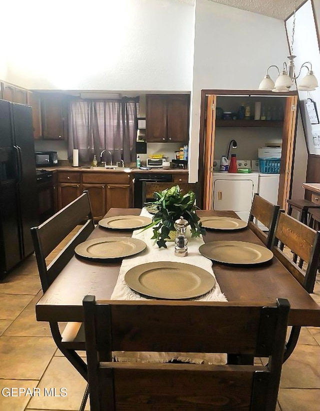1624 Vinton Rd, Anthony, NM 88021 - dining space with separate washer and dryer, light tile patterned floors, and a textured ceiling
