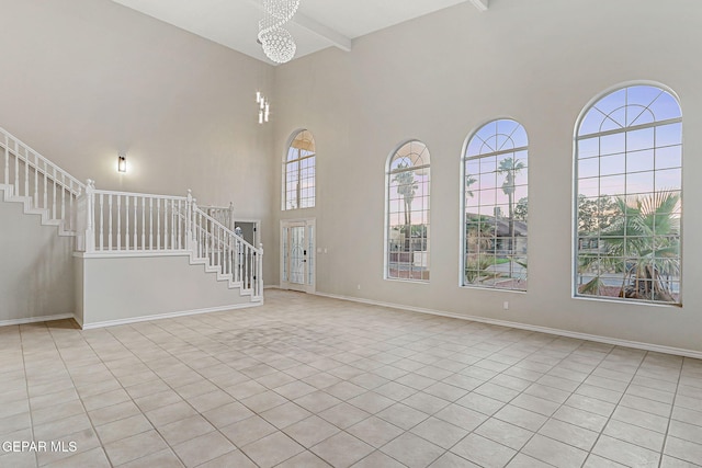 8921 Gemotes Pl, El Paso, TX 79907 - tiled foyer with a high ceiling, stairway, beam ceiling, and a chandelier