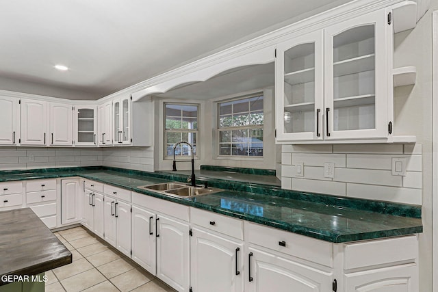 8921 Gemotes Pl, El Paso, TX 79907 - kitchen featuring backsplash, light tile patterned flooring, and white cabinets