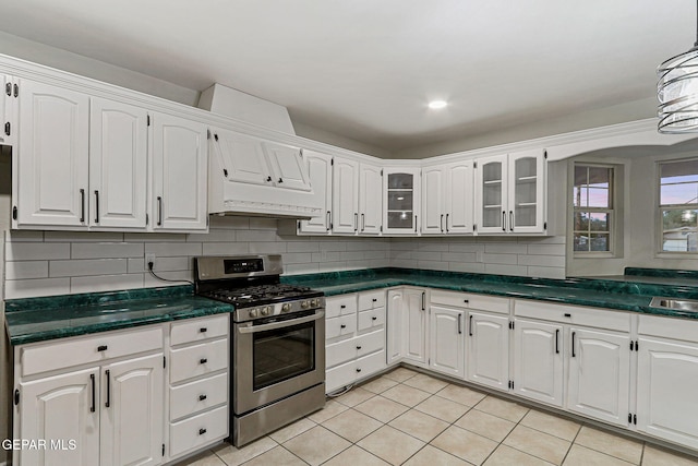 8921 Gemotes Pl, El Paso, TX 79907 - kitchen with gas stove and white cabinetry