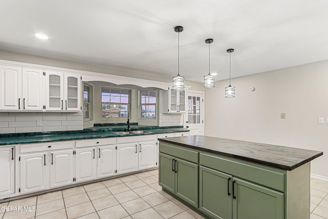 8921 Gemotes Pl, El Paso, TX 79907 - kitchen with green cabinets, white cabinetry, light tile patterned flooring, and glass insert cabinets