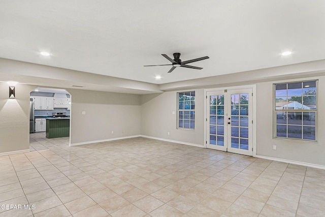 8921 Gemotes Pl, El Paso, TX 79907 - unfurnished room featuring light tile patterned floors, ceiling fan, french doors, recessed lighting, and arched walkways