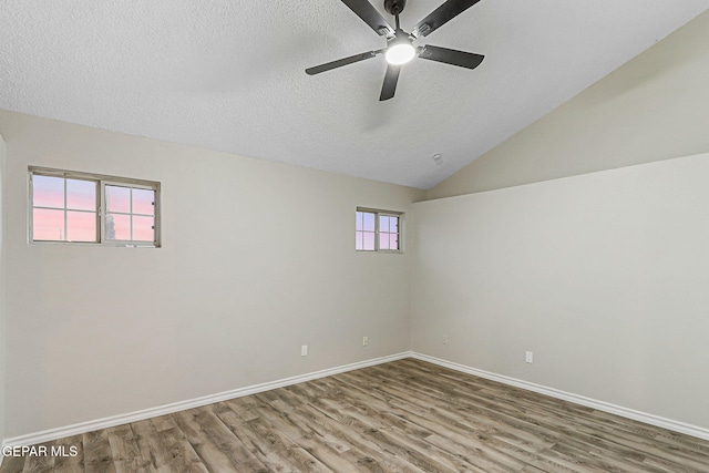 8921 Gemotes Pl, El Paso, TX 79907 - empty room featuring wood finished floors, ceiling fan, a textured ceiling, and vaulted ceiling