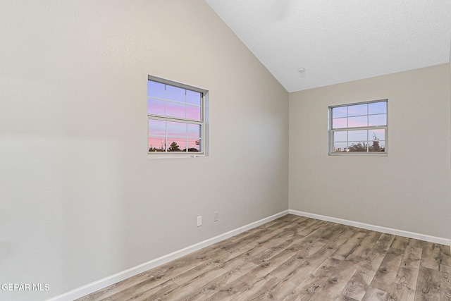 8921 Gemotes Pl, El Paso, TX 79907 - spare room featuring light wood finished floors and vaulted ceiling