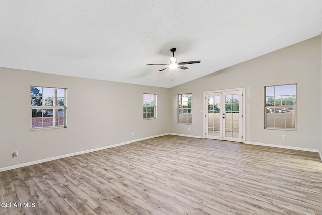 8921 Gemotes Pl, El Paso, TX 79907 - unfurnished room with ceiling fan, french doors, wood finished floors, vaulted ceiling, and a textured ceiling
