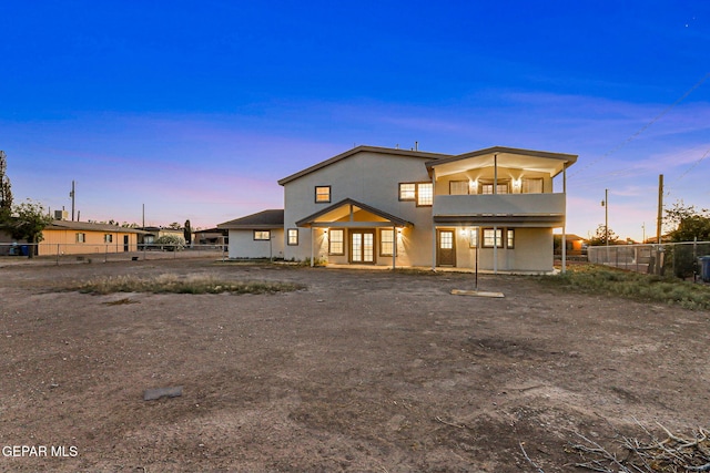 8921 Gemotes Pl, El Paso, TX 79907 - back of house at dusk with a balcony and stucco siding