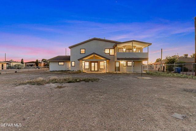 8921 Gemotes Pl, El Paso, TX 79907 - back of house at dusk featuring a balcony and stucco siding