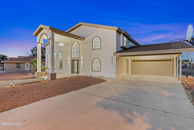 8921 Gemotes Pl, El Paso, TX 79907 - view of front facade featuring a garage, concrete driveway, and stucco siding