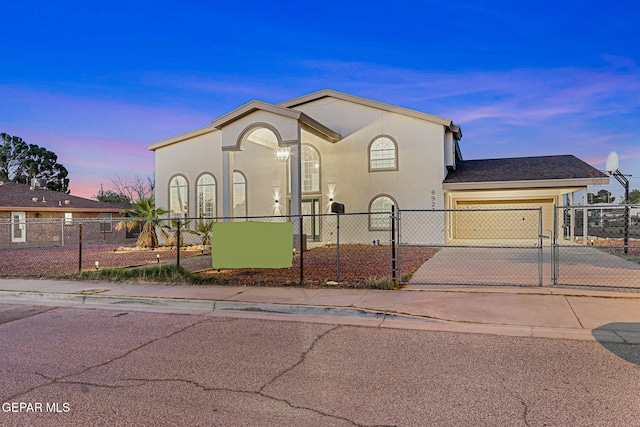 8921 Gemotes Pl, El Paso, TX 79907 - mediterranean / spanish house with driveway, a garage, stucco siding, and a fenced front yard