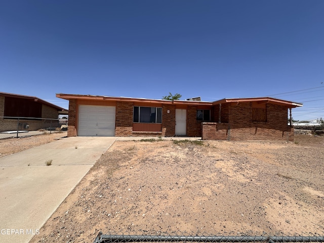 10445 Omega Cir, El Paso, TX 79924 - ranch-style house with an attached garage, driveway, and brick siding