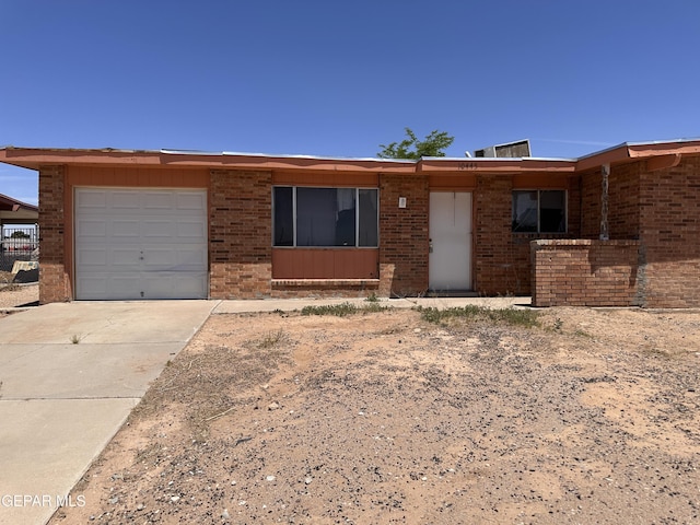 10445 Omega Cir, El Paso, TX 79924 - single story home with brick siding, driveway, and an attached garage