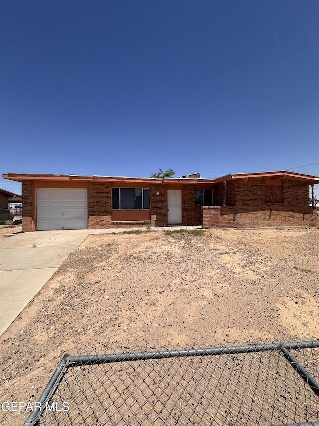 10445 Omega Cir, El Paso, TX 79924 - ranch-style home featuring a garage, concrete driveway, and brick siding
