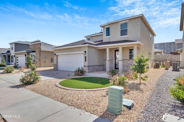 1649 Sam Dominguez, El Paso, TX 79928 - view of front of home with stucco siding, stone siding, a porch, concrete driveway, and an attached garage