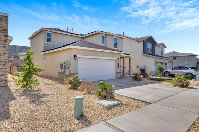 1649 Sam Dominguez, El Paso, TX 79928 - traditional-style house featuring stucco siding, driveway, solar panels, and a garage