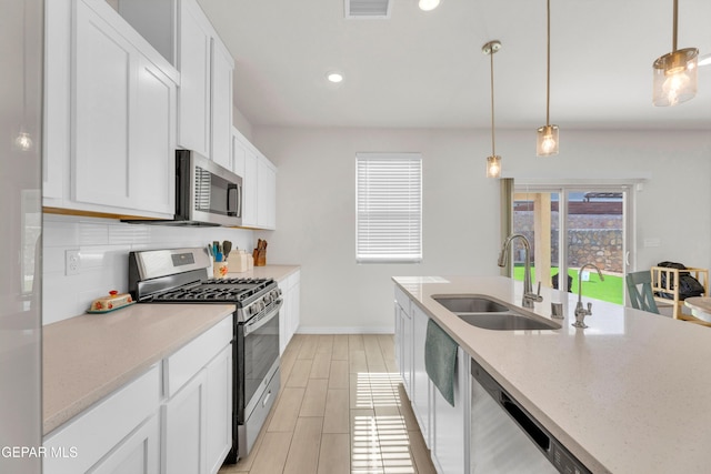 1649 Sam Dominguez, El Paso, TX 79928 - kitchen featuring appliances with stainless steel finishes, white cabinets, decorative light fixtures, and recessed lighting