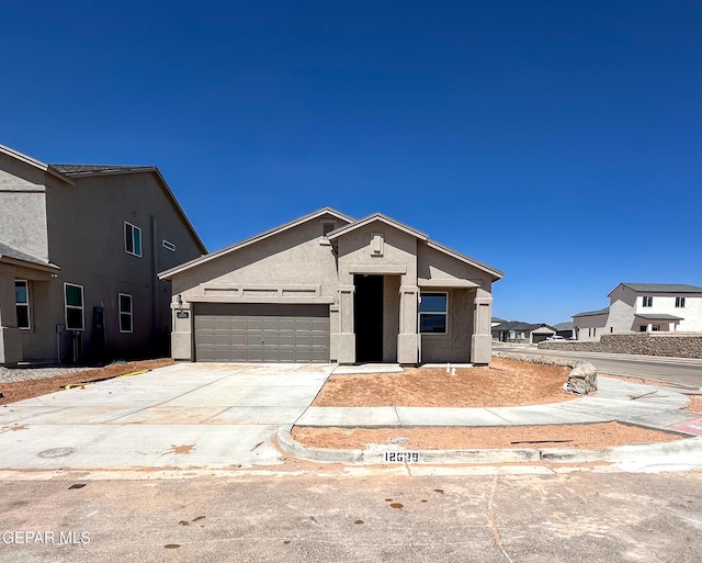 12577 Polo Norte Dr, El Paso, TX 79934 - view of front facade with an attached garage, driveway, and stucco siding