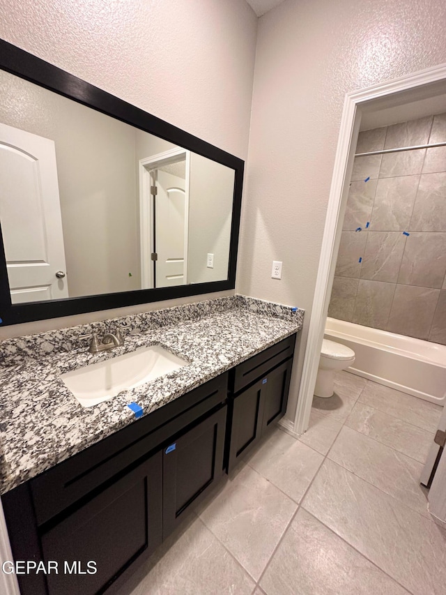 12577 Polo Norte Dr, El Paso, TX 79934 - full bath featuring vanity, tile patterned floors, a textured wall, and bathtub / shower combination