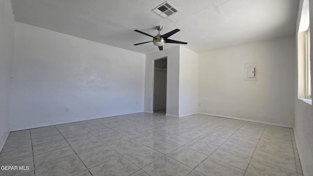 557 Bonampak Dr, San Elizario, TX 79849 - spare room featuring a ceiling fan, tile patterned floors, and a textured ceiling