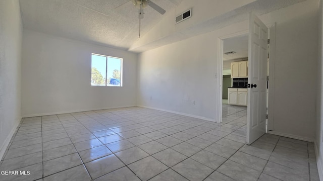 557 Bonampak Dr, San Elizario, TX 79849 - unfurnished room featuring light tile patterned floors, a textured ceiling, and a ceiling fan