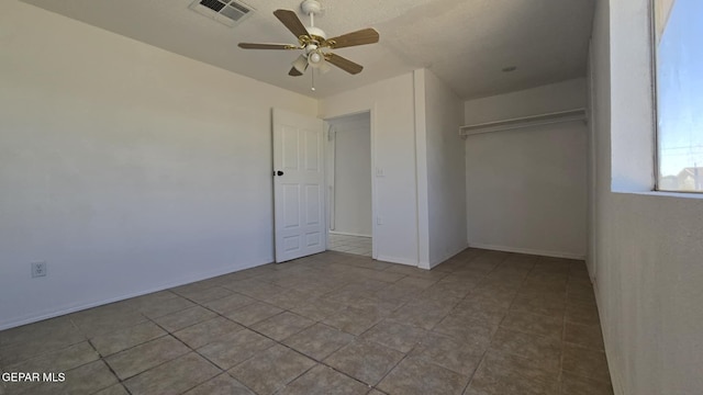 557 Bonampak Dr, San Elizario, TX 79849 - unfurnished bedroom with a closet, tile patterned floors, and ceiling fan
