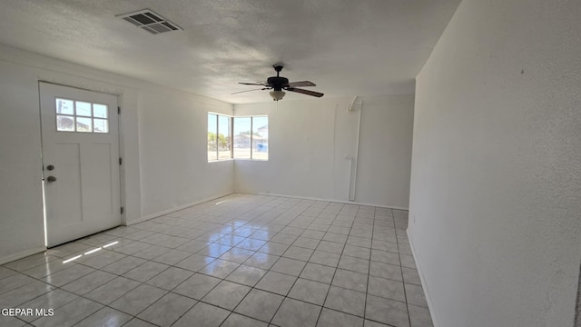557 Bonampak Dr, San Elizario, TX 79849 - foyer featuring plenty of natural light, light tile patterned floors, ceiling fan, and a textured ceiling