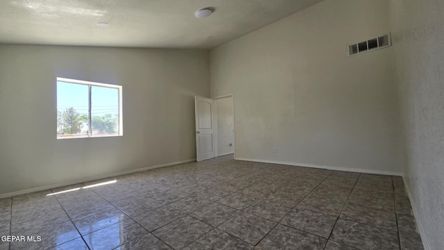 557 Bonampak Dr, San Elizario, TX 79849 - unfurnished room with high vaulted ceiling and tile patterned flooring