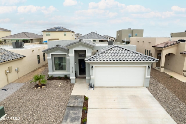 13163 Emerald Isle St, El Paso, TX 79928 - view of front of home with a garage, concrete driveway, a tile roof, and a residential view