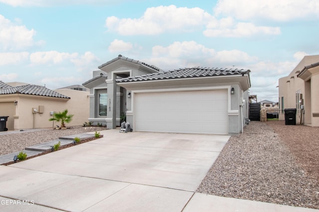 13163 Emerald Isle St, El Paso, TX 79928 - mediterranean / spanish home with concrete driveway, a tile roof, a garage, and stucco siding
