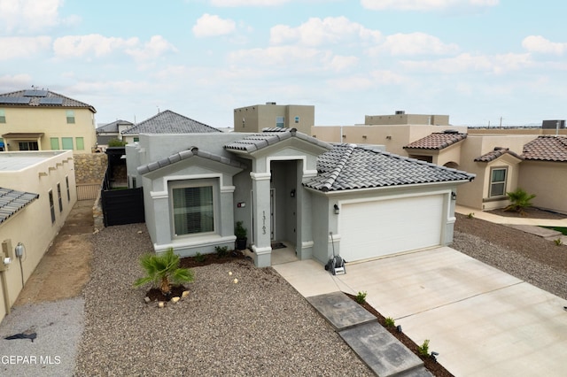 13163 Emerald Isle St, El Paso, TX 79928 - view of front of home with a garage, stucco siding, driveway, and a tiled roof