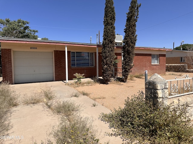 10333 Shoshone St, El Paso, TX 79924 - ranch-style house with driveway, brick siding, and a garage