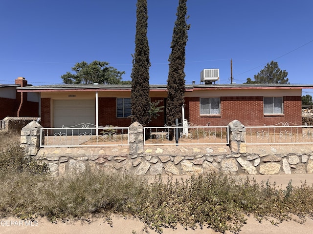 10333 Shoshone St, El Paso, TX 79924 - view of front facade with brick siding, a fenced front yard, and a garage
