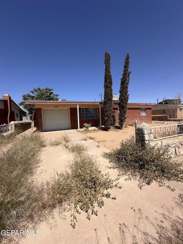 10333 Shoshone St, El Paso, TX 79924 - view of front of house with an attached garage, driveway, and brick siding