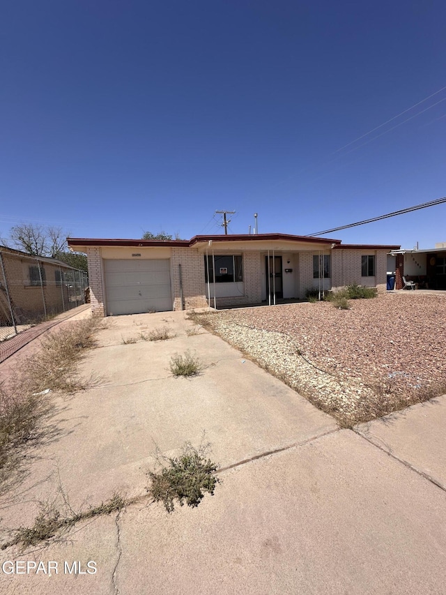 10561 Champlain St, El Paso, TX 79924 - single story home with driveway, a garage, and brick siding