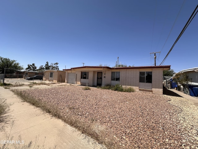 10561 Champlain St, El Paso, TX 79924 - view of front of house with a garage, brick siding, and driveway
