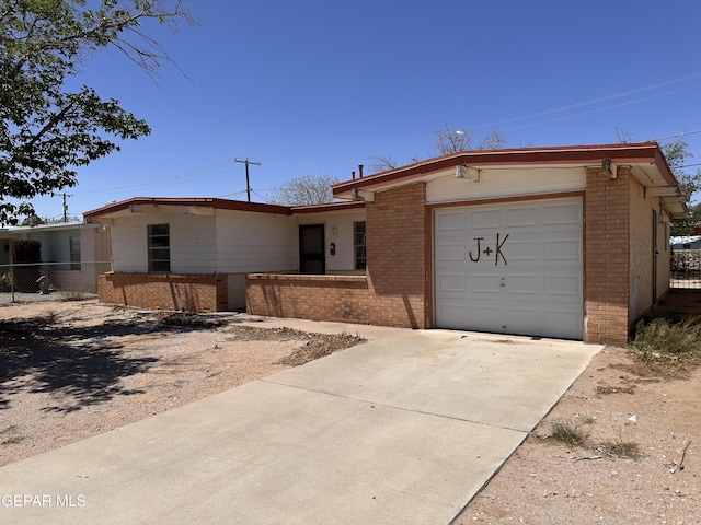 10529 Champlain St, El Paso, TX 79924 - ranch-style home featuring brick siding, an attached garage, and concrete driveway