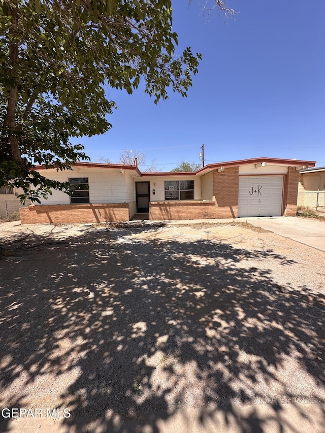 10529 Champlain St, El Paso, TX 79924 - view of front of house featuring brick siding, an attached garage, and concrete driveway