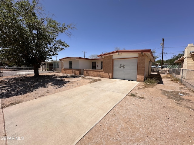 10529 Champlain St, El Paso, TX 79924 - view of front of property featuring brick siding, an attached garage, and driveway