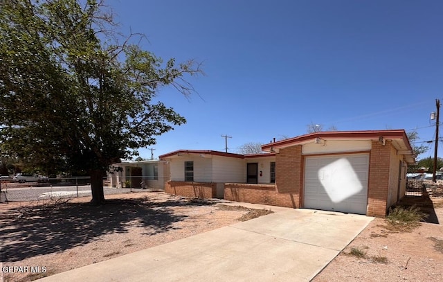 10529 Champlain St, El Paso, TX 79924 - view of front of house featuring brick siding, an attached garage, and driveway