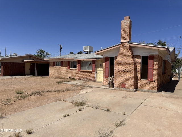 10333 Wilshire Dr, El Paso, TX 79924 - view of front of property featuring a chimney and driveway
