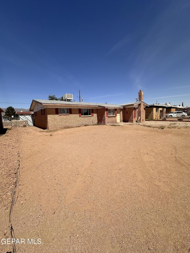 10333 Wilshire Dr, El Paso, TX 79924 - view of front of house with brick siding and a chimney