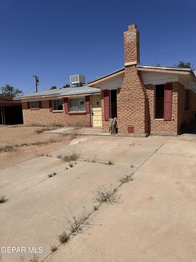 10333 Wilshire Dr, El Paso, TX 79924 - ranch-style house with brick siding and a chimney