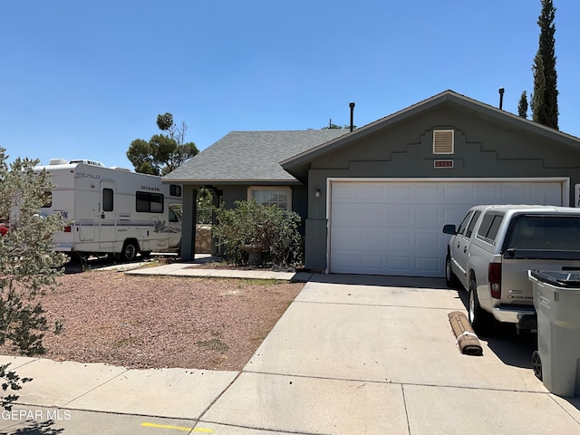 11816 Oxcart Run St, El Paso, TX 79936 - view of front of property featuring concrete driveway, a garage, a shingled roof, and stucco siding
