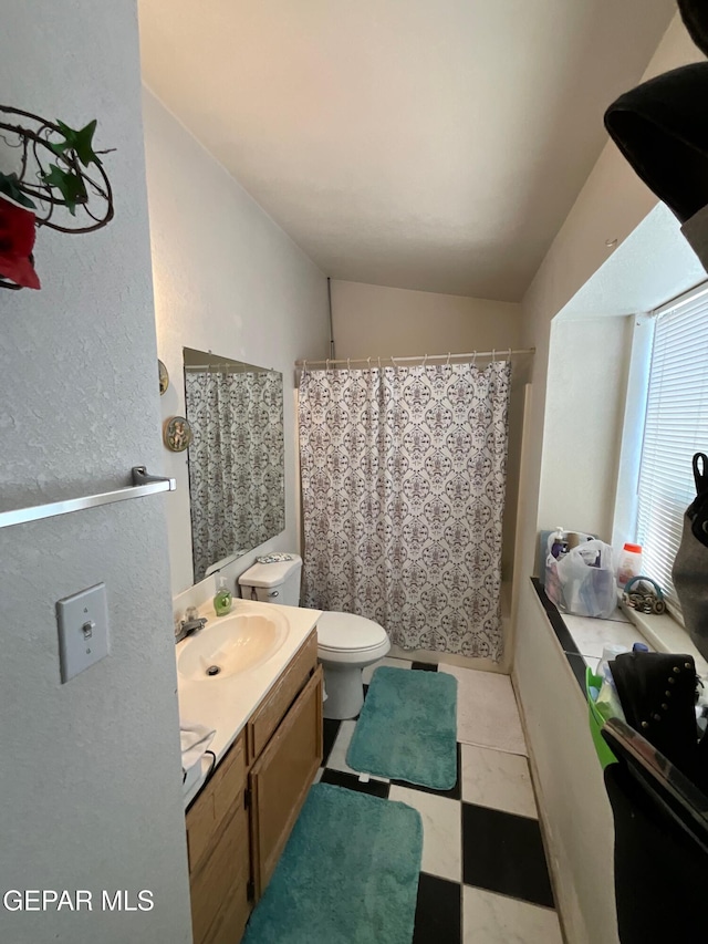 11816 Oxcart Run St, El Paso, TX 79936 - bathroom featuring vanity, vaulted ceiling, tile patterned floors, and a shower with curtain
