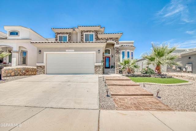 12571 New Dawn Dr, El Paso, TX 79928 - mediterranean / spanish-style house featuring stone siding, stucco siding, concrete driveway, and a garage