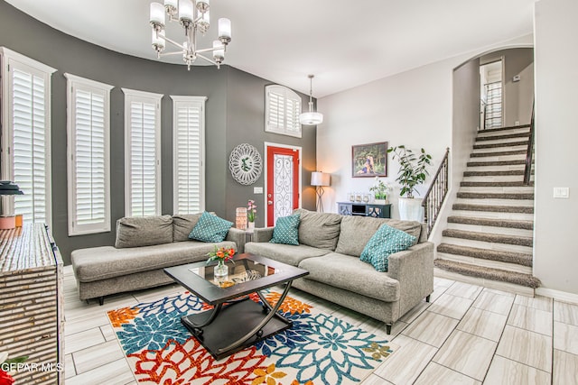 12571 New Dawn Dr, El Paso, TX 79928 - living room featuring arched walkways, stairs, and a chandelier