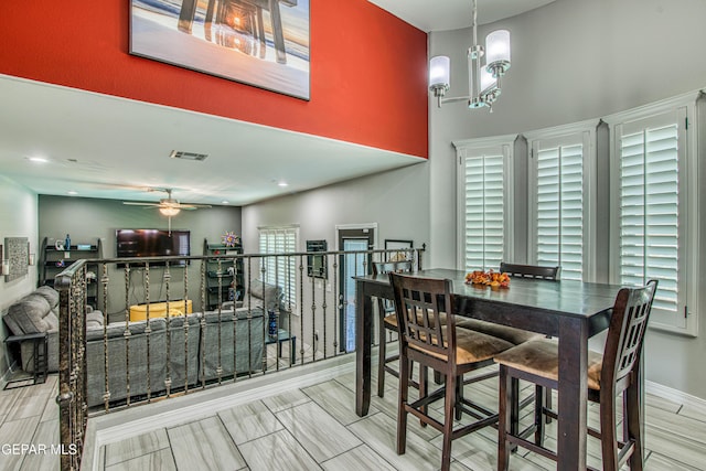 12571 New Dawn Dr, El Paso, TX 79928 - dining space featuring ceiling fan and a chandelier