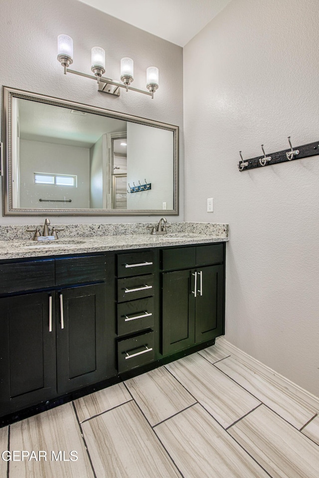 12571 New Dawn Dr, El Paso, TX 79928 - full bath with double vanity and wood finished floors
