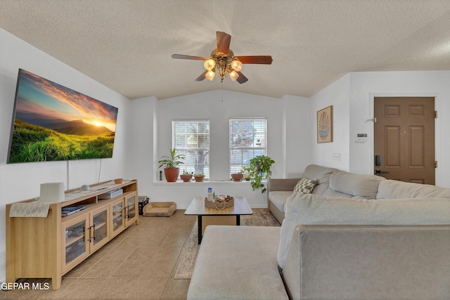 5609 Rick Husband Dr, El Paso, TX 79934 - living room featuring a ceiling fan, vaulted ceiling, a textured ceiling, and light tile patterned floors