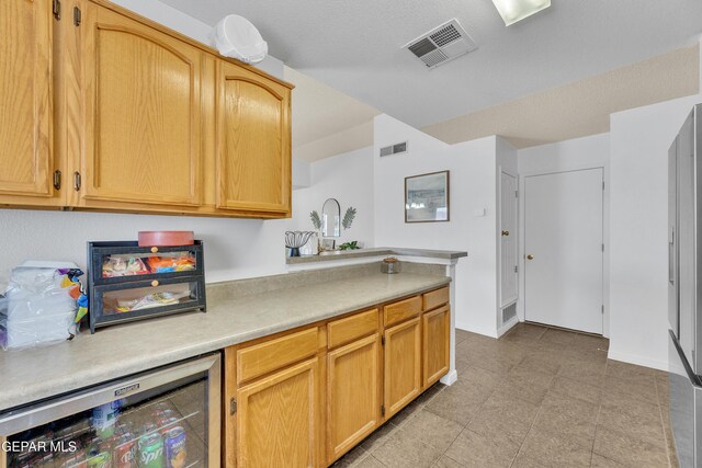 5609 Rick Husband Dr, El Paso, TX 79934 - kitchen with wine cooler and light countertops